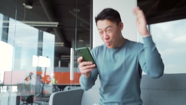 Happy Euphoric Asian Man Freelancer Employee Worker Celebrate Mobile Win — Stockvideo