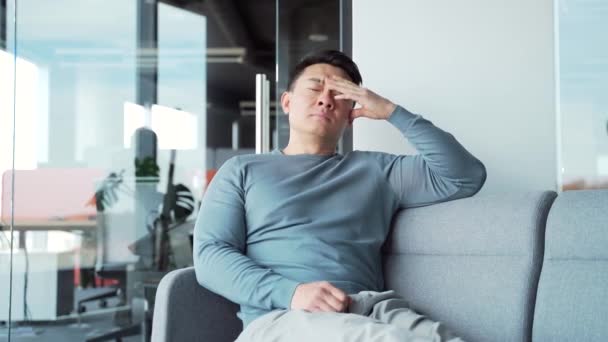 Young Exhausted Overworked Office Worker Sitting Couch Severe Headache Massaging — Stock Video