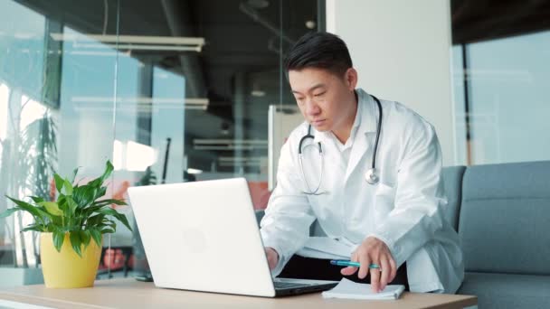 Asian Man Doctor Working Office Desk Modern Hospital Clinic Uses — 图库视频影像