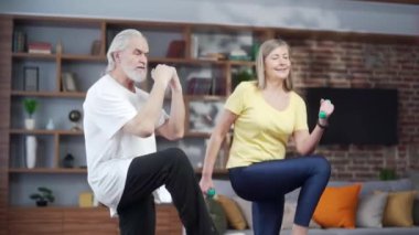 Aktif olgun yaşlı çift gerinme egzersizi yapıyor ve evde yoga yapıyor. Pilates, fitness ya da jimnastik yaparken mutlu, kır saçlı bir aile. Sağlıklı Yaşam Tarzı