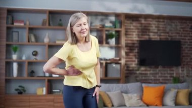 Senior mature woman pain in the right side of the abdomen, appendix, gynecological diseases. Elderly female having painful stomachache. suffering from abdominal pain. After fitness workout at home