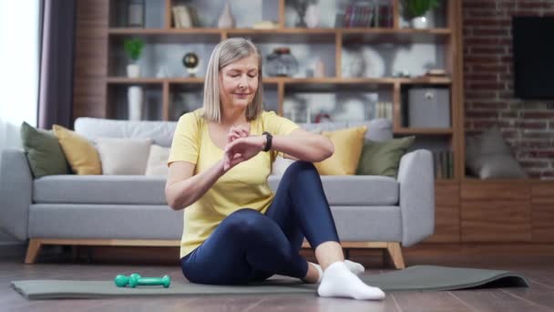 Active Woman Senior Female Uses Smart Watch While Training Home — Stockvideo