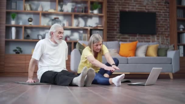 Active Mature Senior Couple Performing Stretching Exercise Practicing Yoga Home — Vídeo de Stock