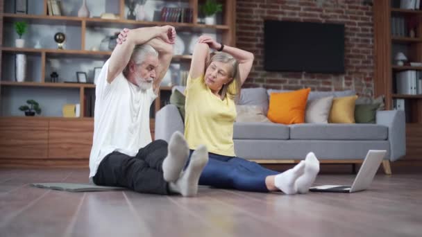Active Mature Senior Couple Performing Stretching Exercise Practicing Yoga Home — Vídeo de Stock