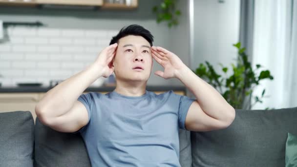 Tired Sick Man Home Alone Asian Has Headache Sits Couch — Stock Video