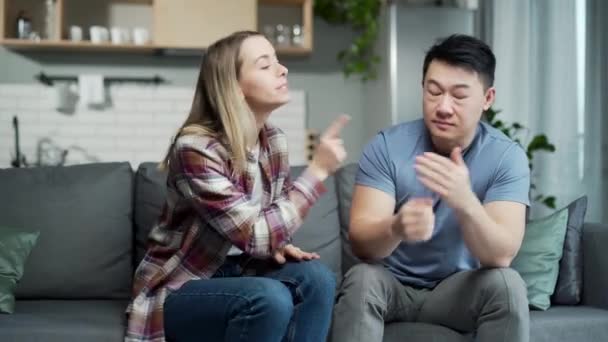 Domestic Violence Woman Quarreling Husband Nervous Asian Man Sitting Couch — Stock Video