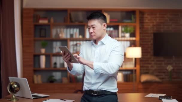 Happy Young Asian Employee Uses Smartphone Office Satisfied Business Man — Stockvideo