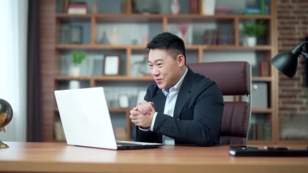 Excitable Asian Man Screams Joy Waves Hands Looks Laptop Screen — Vídeo de Stock