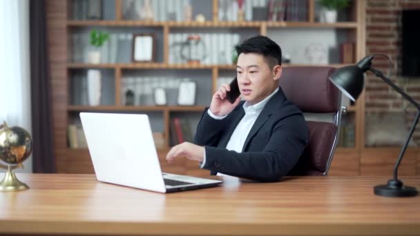 Satisfied Asian Business Man Talking Mobile Phone While Sitting Office — Stockvideo