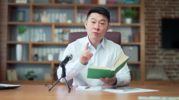 Asian Preacher Reads Bible Online Records Podcast Sits Table Looks — Video Stock