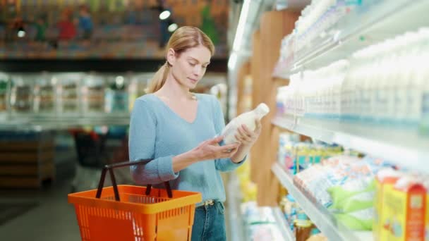 Woman Chooses Dairy Products Holding Bottle Milk Her Hands Female — Vídeo de stock