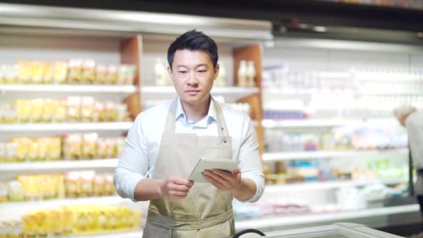 Asian Grocery Store Manager Salesman Apron Using Digital Tablet Counting — Video