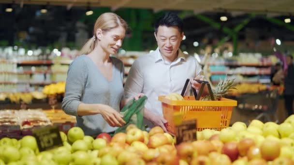 Happy Mixed Race Asian Couple Family Man Woman Choosing Fruits — Stock video