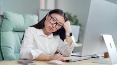 exhausted from stress overworked young asian woman worker in office at computer desk suffering depression and anxiety at work. Employee entrepreneur at workplace headache, tired female with problems