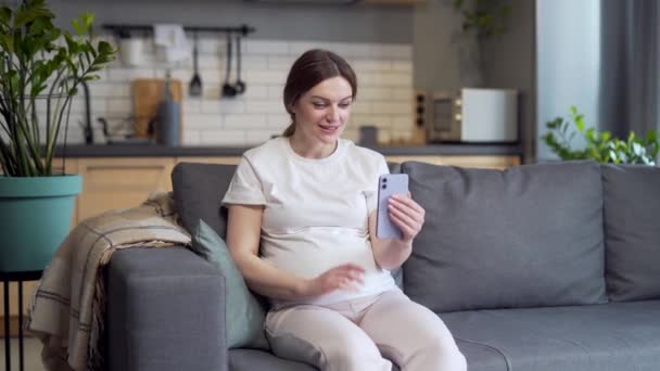Young Pregnant Caucasian Woman Communicates Online Video Call Using Smartphone — Stockvideo