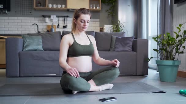 Young Active Pregnant Woman Doing Yoga Exercises Sitting Mat Lotus — стоковое видео