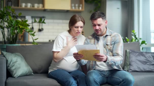 Upset Worried Couple Man Pregnant Woman Home Open Envelope Received — стоковое видео