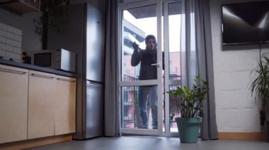 Burglar robber break door lock and entering building apartment. house robbery, Home Burglary. intruder or thief stealing private property indoor after hearing the activation alarm alert run away