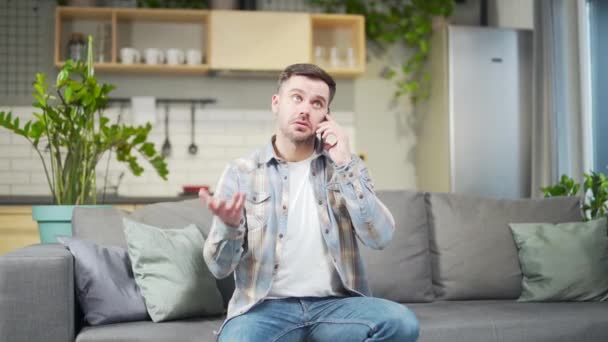 Young Happy Bearded Handsome Caucasian Man Talking Phone Sitting Home — Vídeo de stock