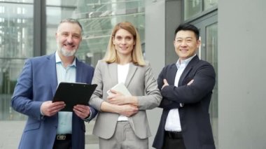 portrait team mature university or college teachers. lecturers or professors in formal suits. Business people looking at camera. Group employees, entrepreneurs smile background office building outside