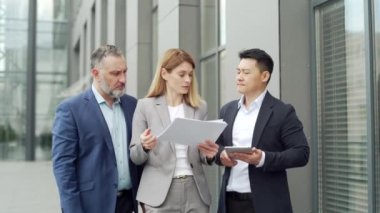 dissatisfied with the results, boss or director quarrels, scolds employees looking at report document Angry manager with bad work financial performance standing with workers outside office building