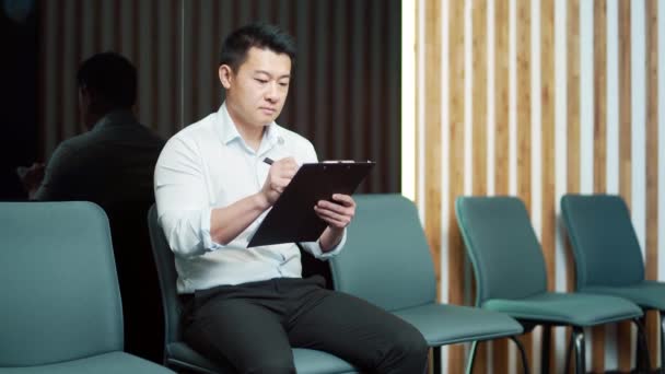 Young Asian Male Waiting Room Job Interview Meeting Thoughtful Employee — Stock Video