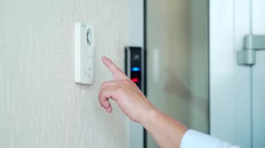 Kapalı erkek el parmağı dahili düğme kapı ziline basar. Daireye ya da ofise uzaktan arama yaparak kapıyı açar. Bir misafir geldiğinde bildirimde bulunur.