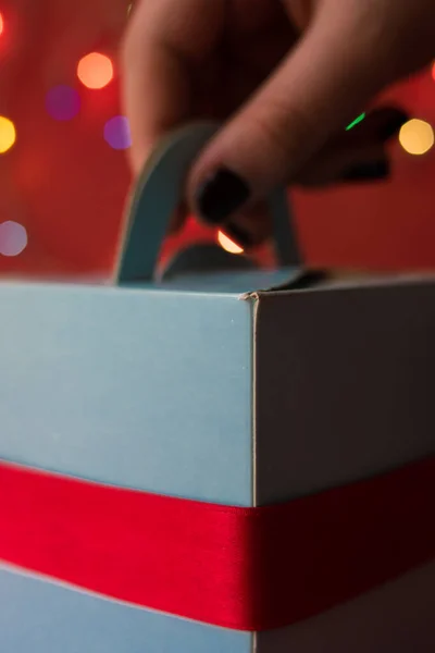Χέρι Λαμβάνοντας Ένα Μπλε Κουτί Δώρου Μια Κόκκινη Κορδέλα Μια — Φωτογραφία Αρχείου
