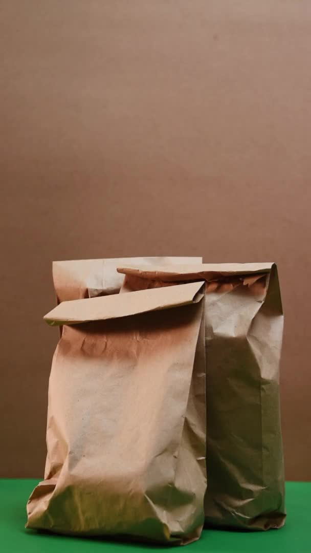 Vertical Video Caucasian Hand Taking Some Paper Bags Paper Texture — Stockvideo