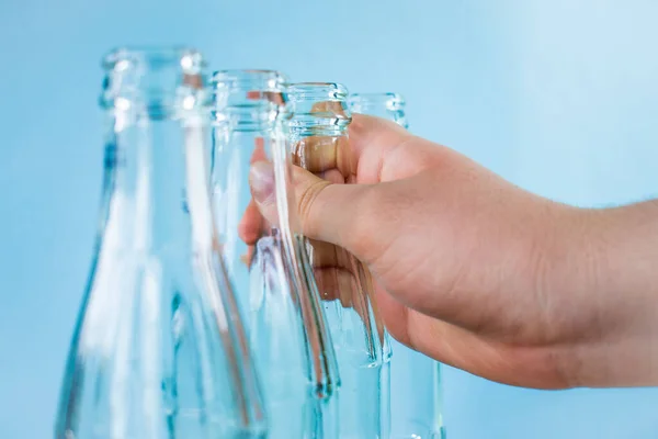 Caucasian Hand Leaving Glass Bottle Other Bottles Bright Blue Background Fotografias De Stock Royalty-Free