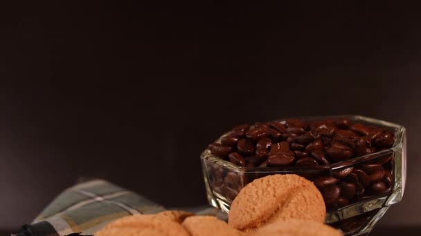 黒の背景に手で残された熱い飲み物のためのコーヒー豆 クッキー プラスチック製の魔法瓶 — ストック動画