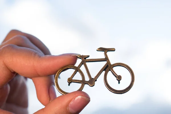 Hand Holding Golden Bike Pin Cloudy Sky Background Imagem De Stock