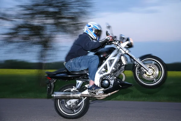 Motorbiker ride on the rear whee — Stock Photo, Image