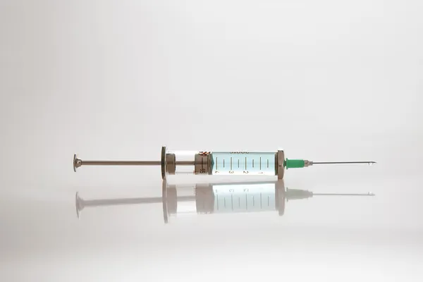 Syringe with needle and fluid — Stock Photo, Image