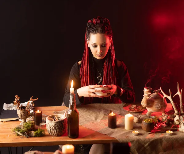 Witch Sits Table Looks Bowl Girl Red Hair Braided Pigtails Obrazy Stockowe bez tantiem