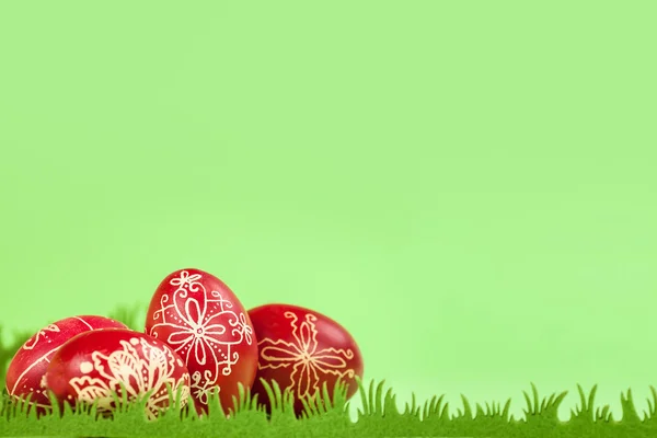 Traditional eastern eggs on artificial green grass — Stock Photo, Image