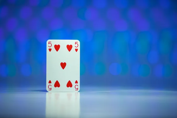 Rotes Herz fünf Spielkarte mit blauem verschwommenen Kreis Hintergrund Stockfoto