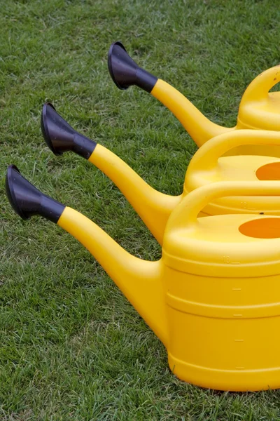 Yellow watering cans — Stock Photo, Image