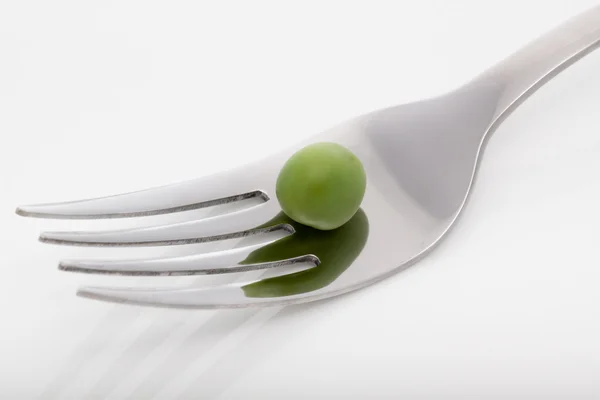 Green pea with fork — Stock Photo, Image