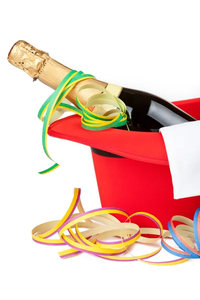 Red top hat with champagne and streamers — Stock Photo, Image