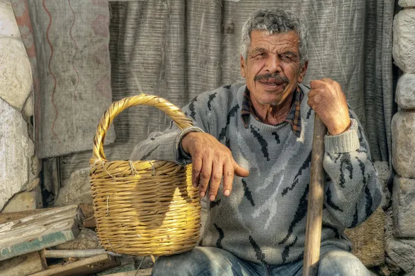 Senior farmer holding a basket and resting — Stock Photo, Image