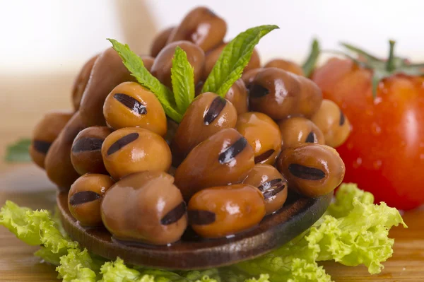 Lebanese broad beans in wood spoon — Stock Photo, Image