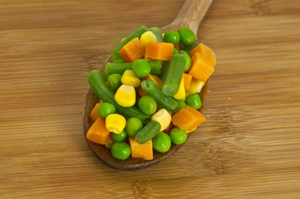 Diced vegetables in wood spoon — Stock Photo, Image