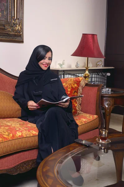 Arabian lady reading magazine