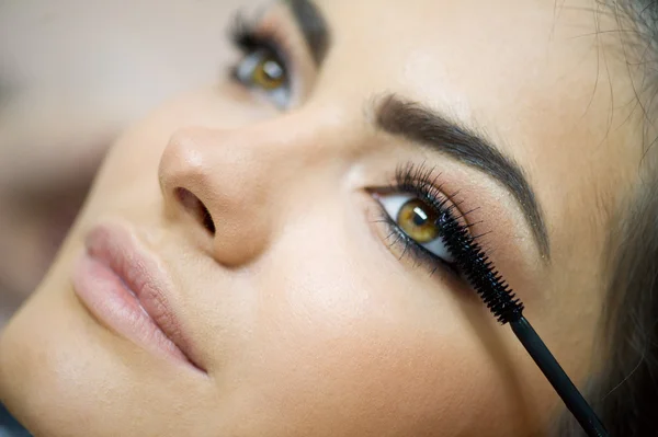 Donna che applica Mascara — Foto Stock