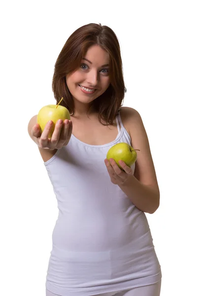 Mujer joven ofreciendo dos manzanas verdes . —  Fotos de Stock