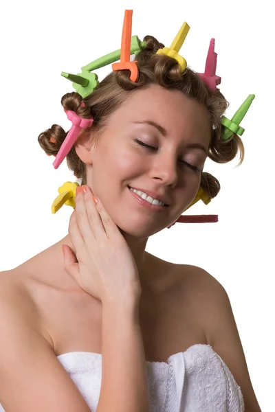 Smiling pretty woman with closed eyes and curlers on hair. — Stock Photo, Image