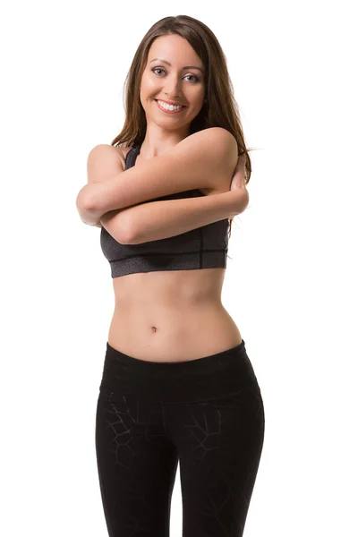 Mujer sonriente calentando su cuerpo . — Foto de Stock