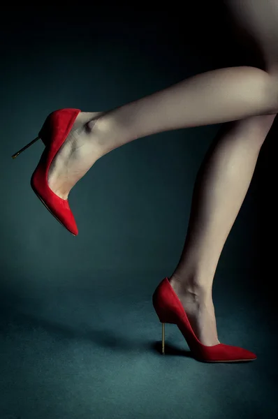 Червоні високі підбори на красивих жіночих ногах — стокове фото