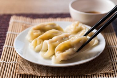 Buharda pişirilmiş hamur tatlısı. Kıymalı domuz eti ve susam yağı sosuyla birlikte yenir. Yemek çubukları, Asya yemekleri.